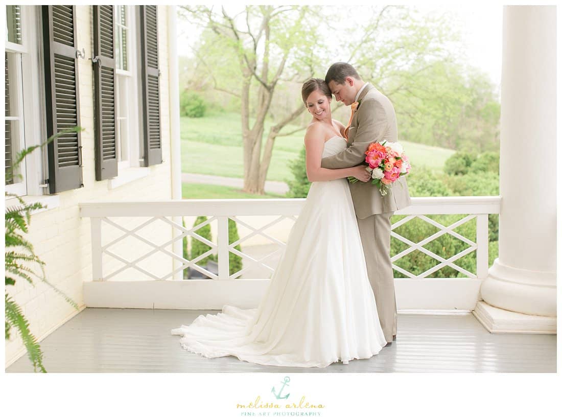 Bride and Groom posing on the porch of The Inn at Willow Grove