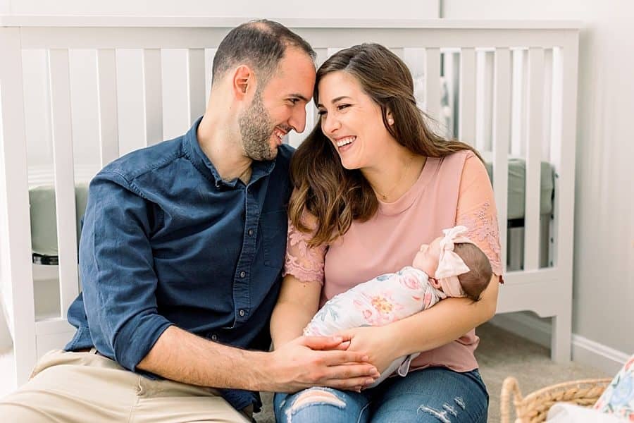 Happy Miami parents with newborn daughter during lifestyle session